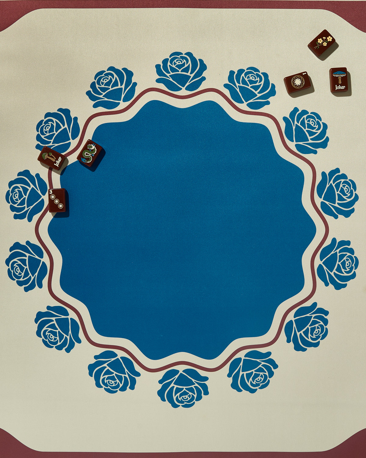 Briar mahjong mat with blue roses and a few mahjong tiles