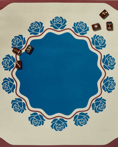 Briar mahjong mat with blue roses and a few mahjong tiles