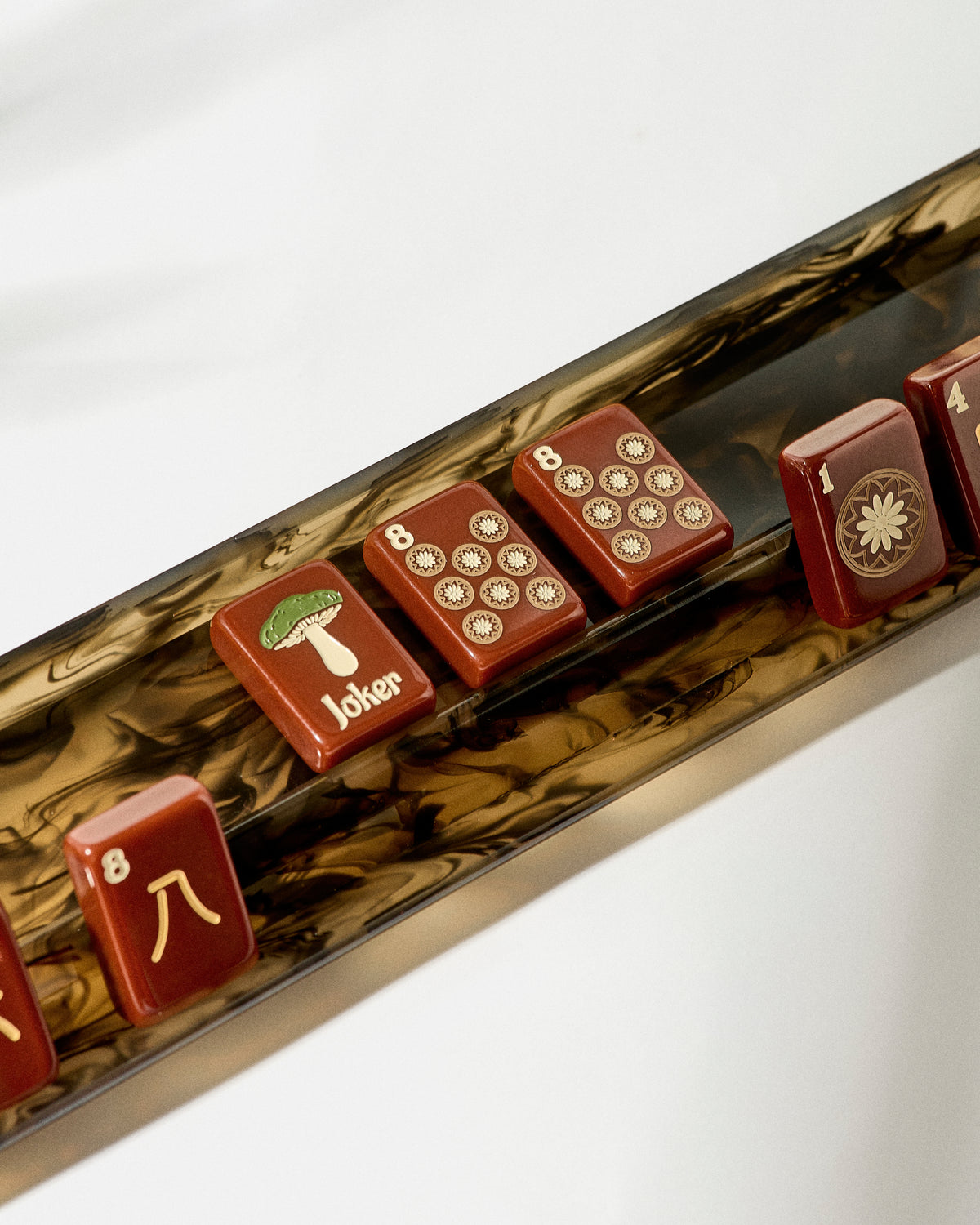Close-up of the Moss mahjong rack holding Redemption Line tiles