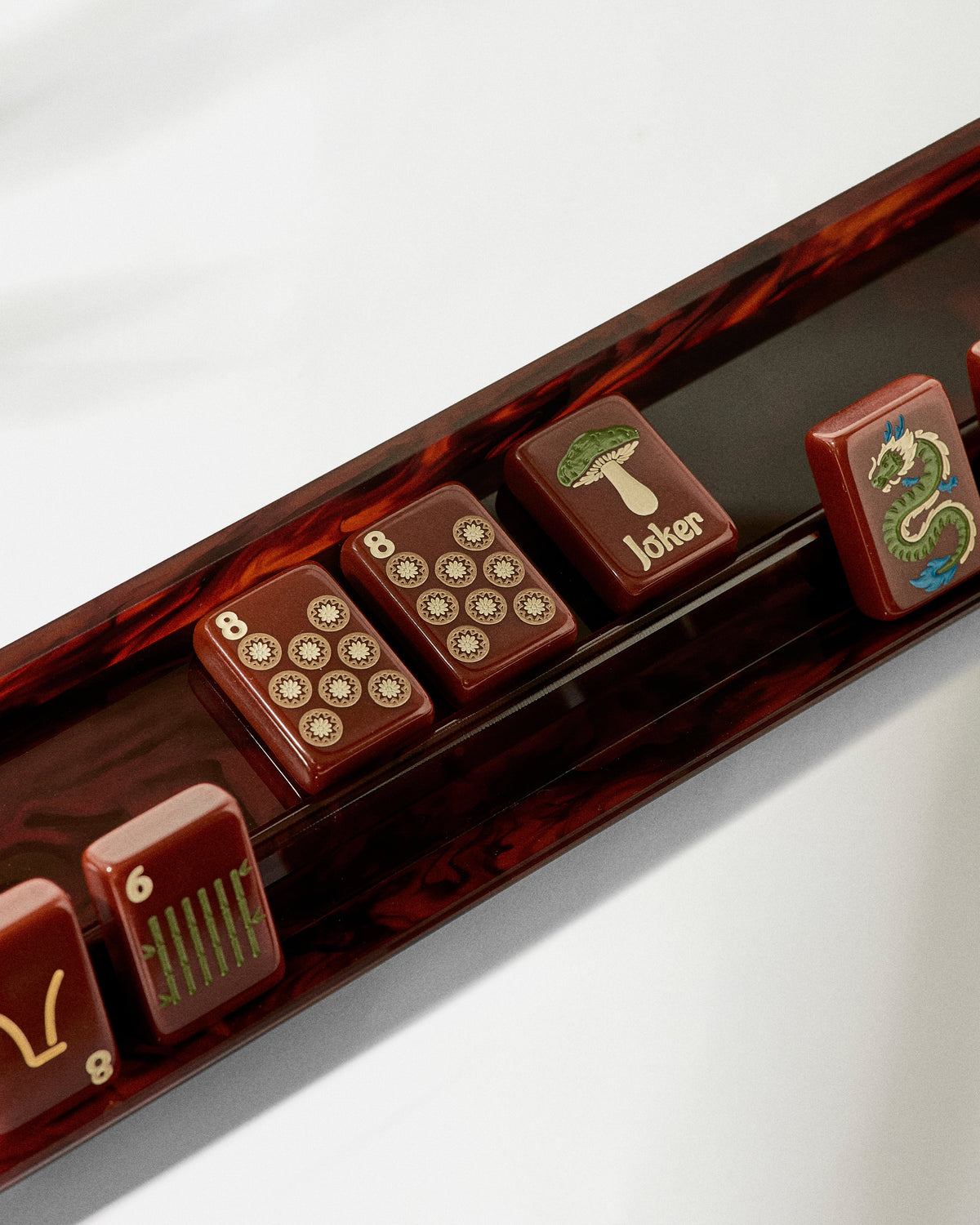 Close-up of the Tobacco Smoke mahjong rack holding Redemption Line tiles