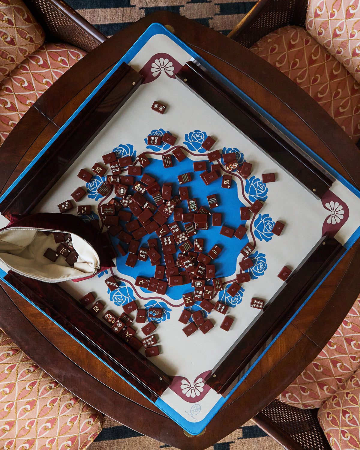 Briar mahjong mat on a mahjong table covered in tiles, seen from above