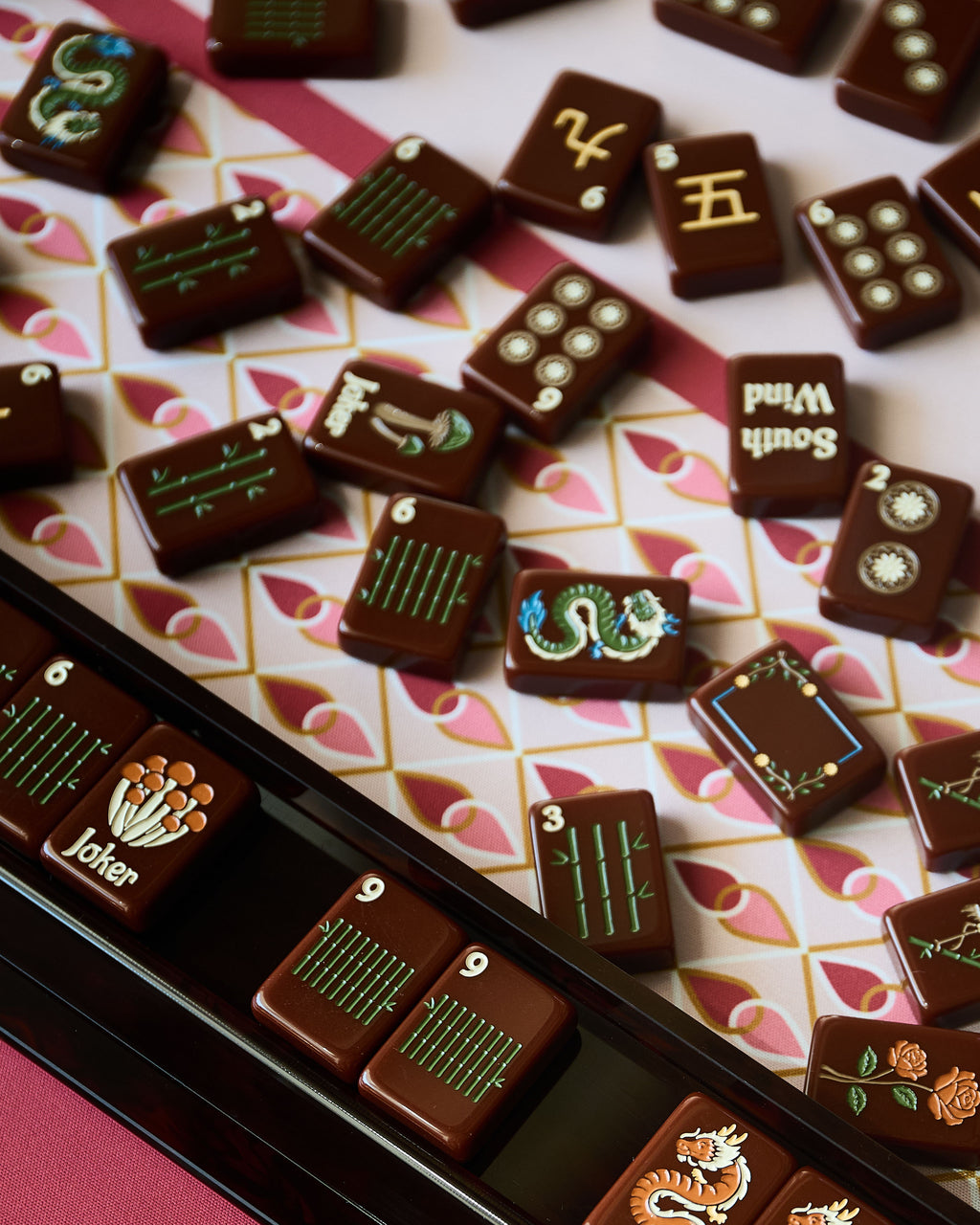 Close-up of Redemption Line mahjong tiles and a rack on the Currant mahjong mat