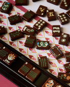 Close-up of Redemption Line mahjong tiles and a rack on the Currant mahjong mat